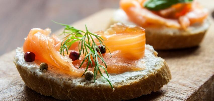 TH05_smoked-salmon-canapes-on-a-brown-wooden-plate-picture-id181900665